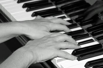 Hands on piano black and white